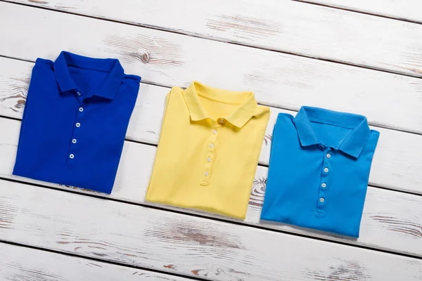 Yellow, navy and blue t-shirts.