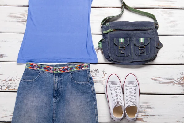 Denim skirt with a blue tank top.