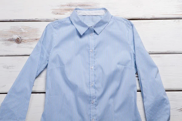 Blue shirt with long sleeves.