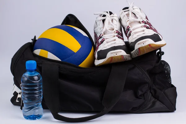 Sports bag with sportswear and ball.