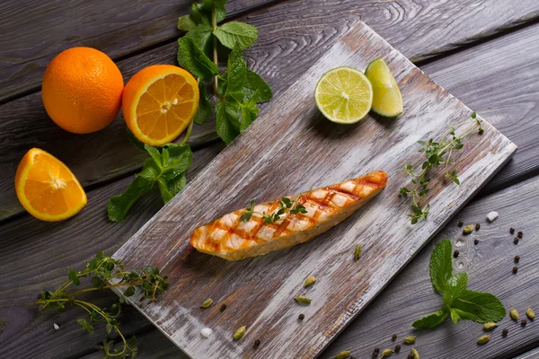 Grilled salmon steak with fresh herbs.