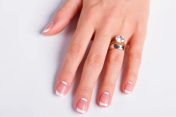 Diamond ring and wedding ring on woman\'s finger.