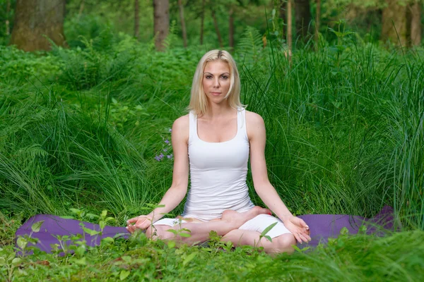 Woman practices yoga in nature
