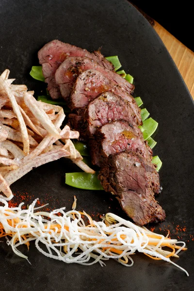 Lemongrass grilled beef steak with snow peas