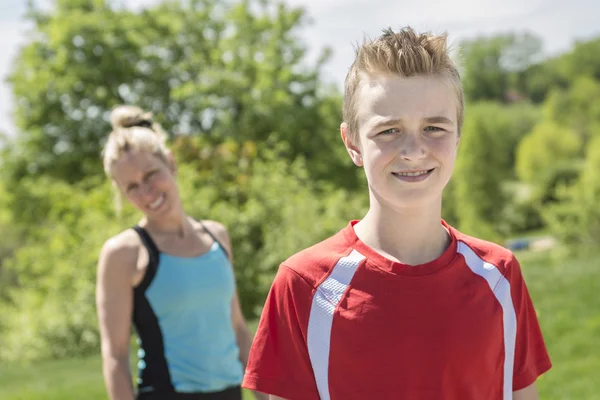 Family, mother and son are running or jogging for sport outdoors