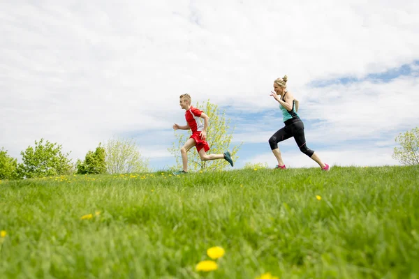 Family, mother and son are running or jogging for sport outdoors