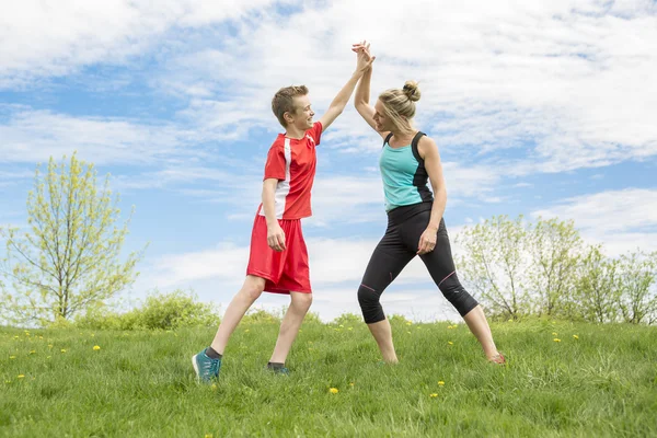 Family, mother and son are running or jogging for sport outdoors