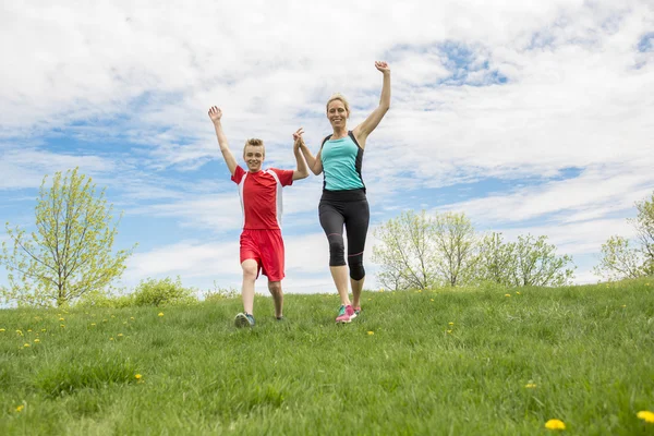 Family, mother and son are running or jogging for sport outdoors