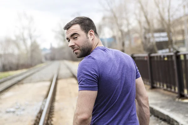 Nice young man portrait on the railroad