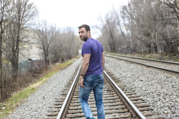 Nice young man portrait on the railroad