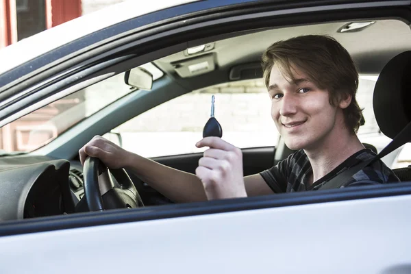 Teenage boy and new driver behind wheel of his car