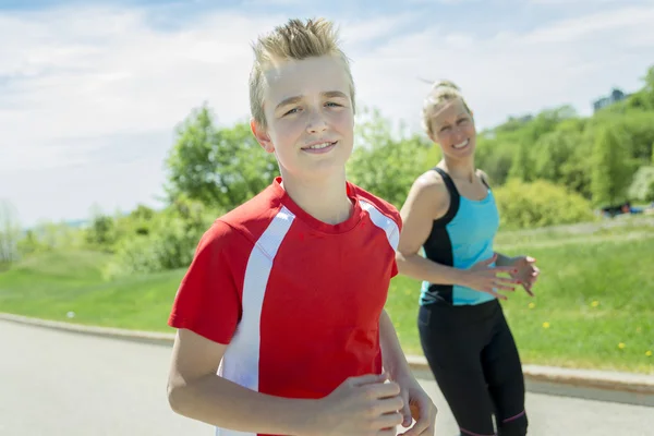 Family, mother and son are running or jogging for sport outdoors