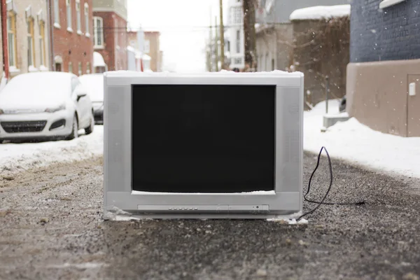 Old TV left on the street winter