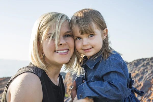 Mother and daughter on the beach side having fun