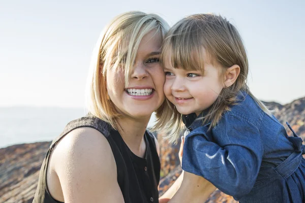 Mother and daughter on the beach side having fun