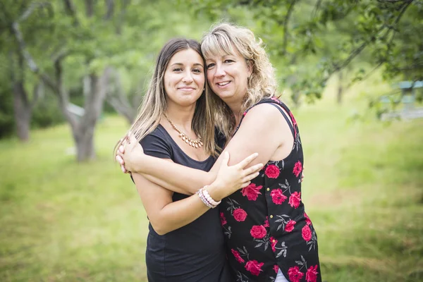 Adult mother and daughter outside in forest