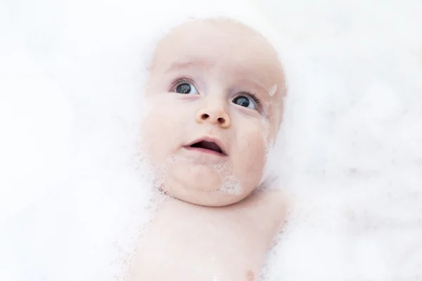 Toddler showing face just above water surface.