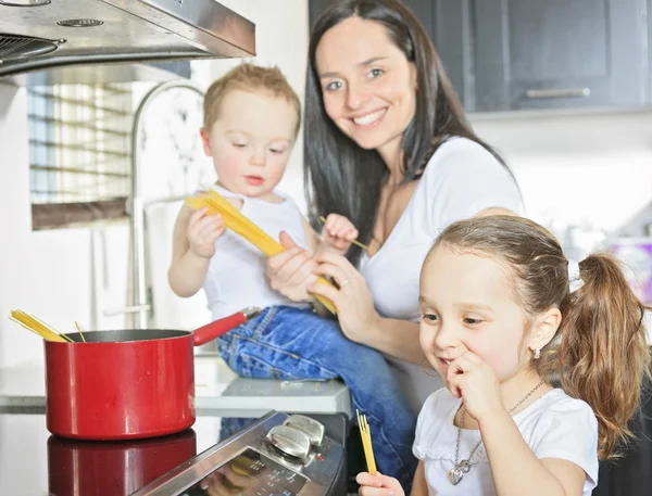 A family cook pasta inside the kitchen