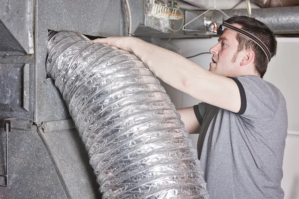 Ventilation cleaner man at work with tool