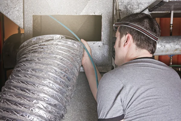 Ventilation cleaner man at work with tool