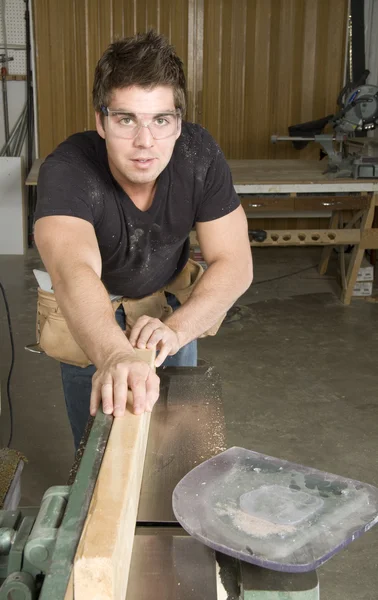 Carpenter at work on job using power tool