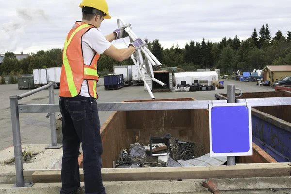 A worker who recycling thing on recycle center