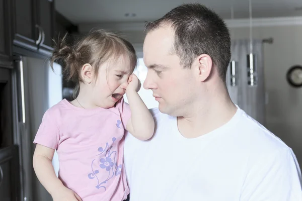 Angry upset girl with father inside the house