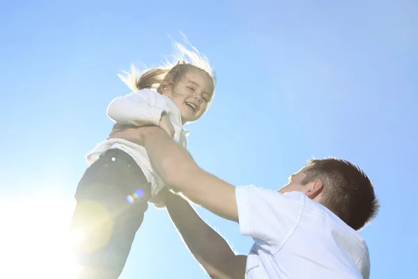 A Father and Daughter having fun play outside