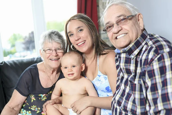 Portrait of happy mature couple with daughter and granddaughter