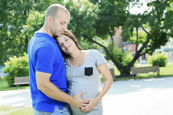 A portrait of a pregnant wife with her husband.