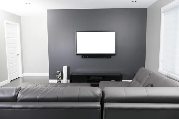 A gray and white living room with tv stand and sofa