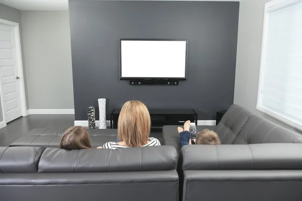 Family sitting on a sofa in her living room
