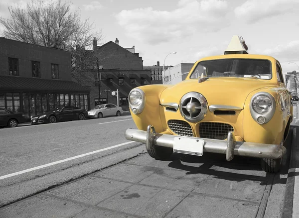 A vintage antique yellow taxi cab on city streets of New york