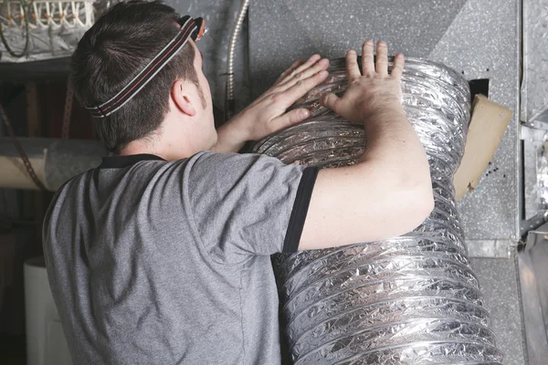 A ventilation cleaner man at work with tool