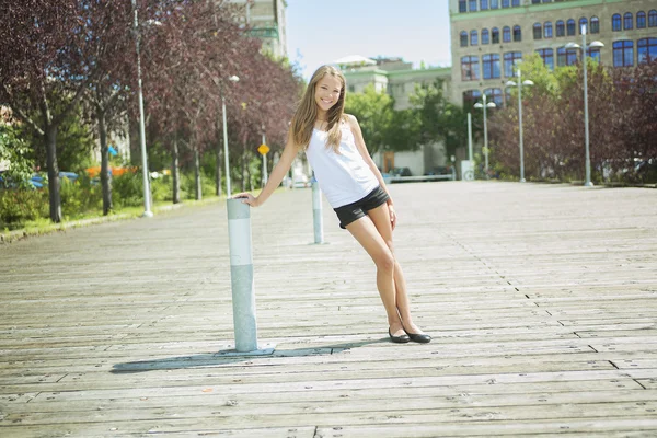 Young long-haired teen girl standing outside