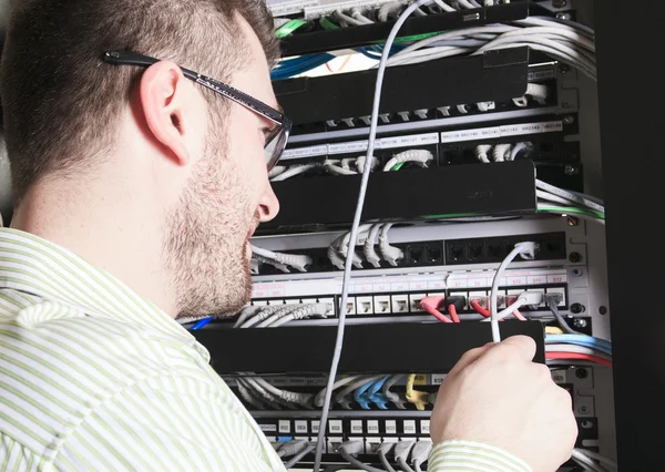 Network engineer working in server room