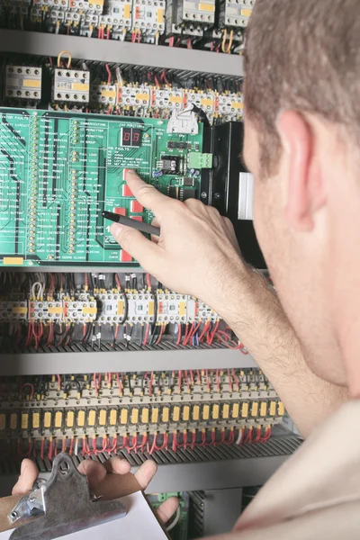 Machinist worker technicians at work adjusting lift with spanner