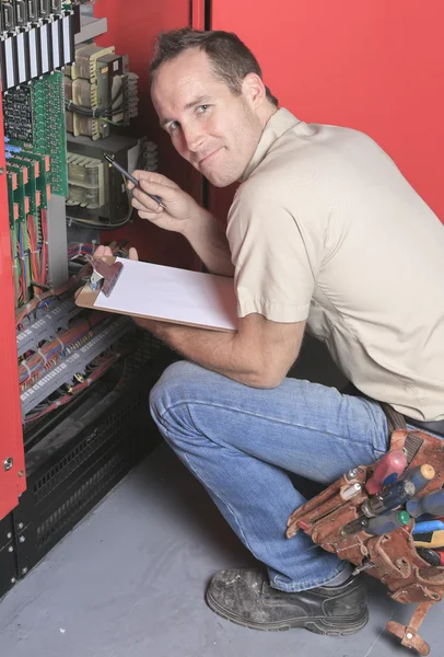 Machinist worker technicians at work adjusting lift with spanner