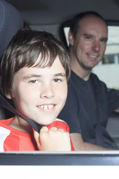 Portrait of smiling boy in the car of his father