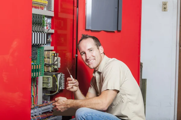 Machinist worker technicians at work adjusting lift with spanner