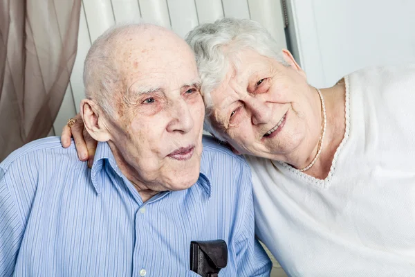 Close-up portrait of an elder couple at home