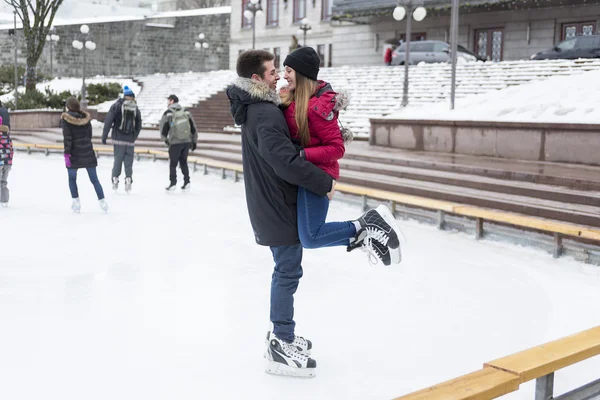 Ice skating couple having winter fun on ice skates Quebec, Canada.