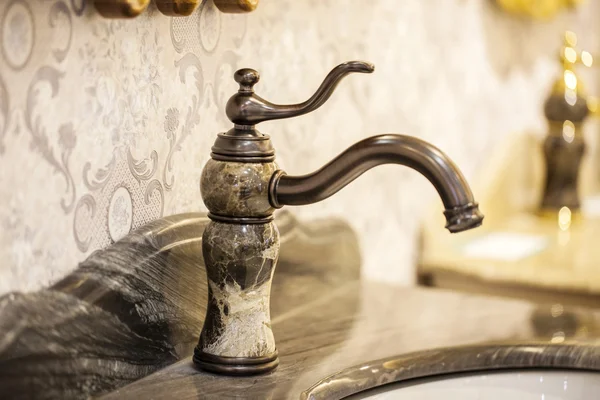 Closeup of water-supply faucet isolated in modern bathroom