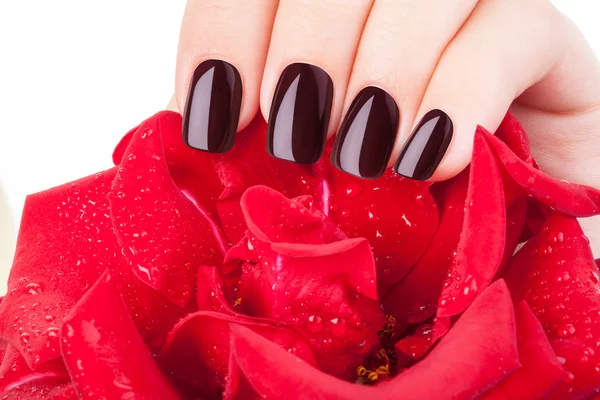 Dark red nail polish.