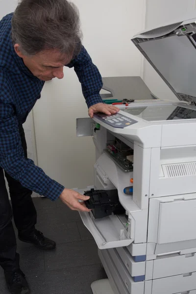 Maintenance Technician is trying to repair a printer