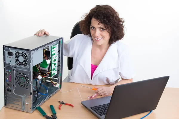 Technician female tests electronic equipment in service centre