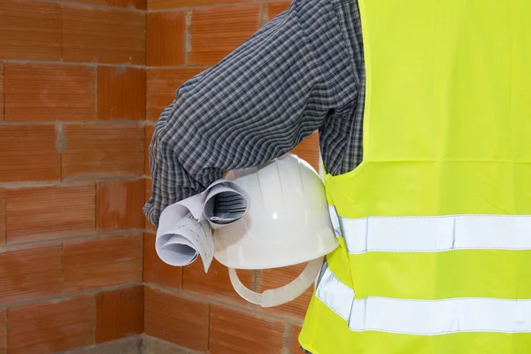 Construction Worker holding a white helmet