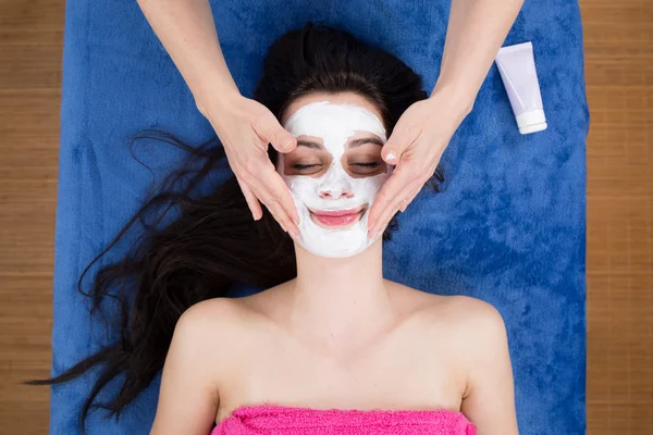 Woman getting a beauty mask at wellness center