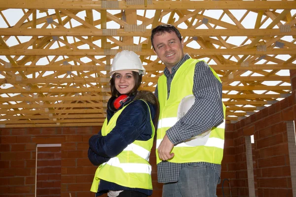 Man and woman, a business partners at the construction site