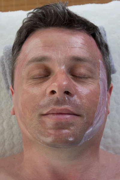 Close up of a man man with facial mask smiling